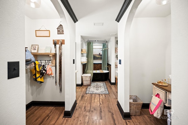 hallway with hardwood / wood-style flooring