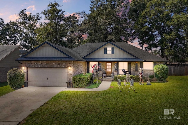 view of front of house with a garage and a lawn