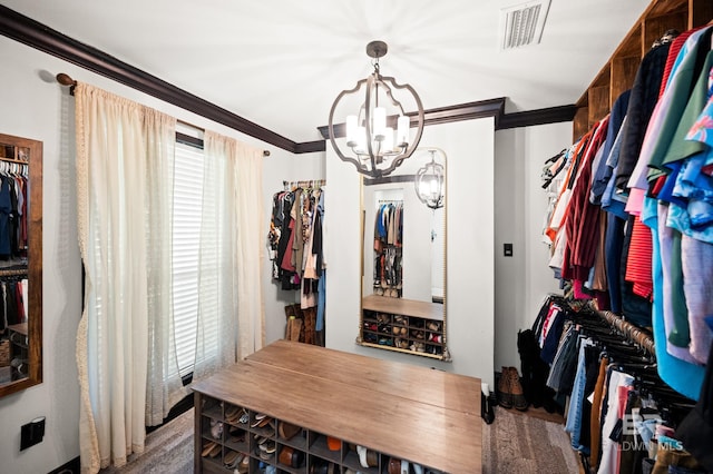 walk in closet featuring hardwood / wood-style floors and an inviting chandelier