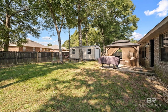 view of yard featuring a gazebo and a shed