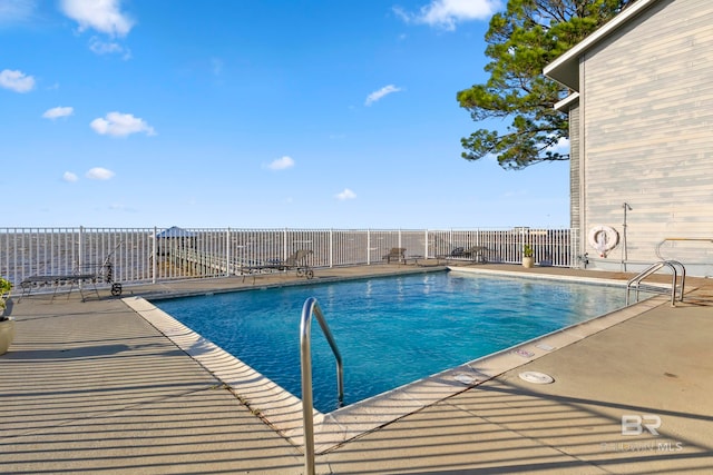 view of swimming pool with a patio