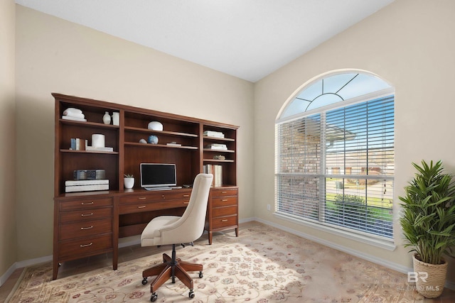 home office with baseboards, plenty of natural light, and lofted ceiling