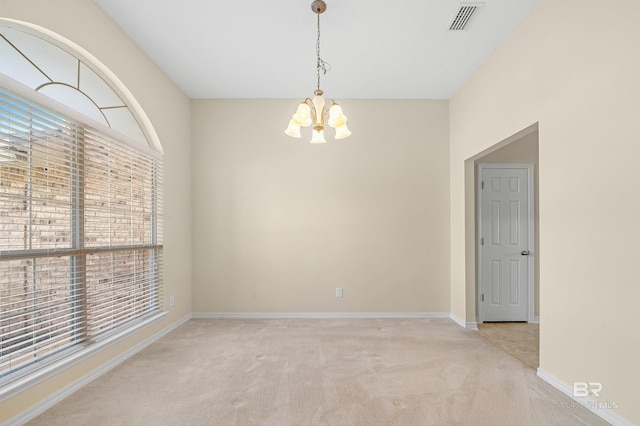 unfurnished room with carpet flooring, a notable chandelier, baseboards, and visible vents