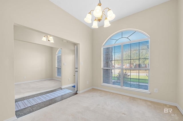 entrance foyer with tile patterned flooring, baseboards, carpet, vaulted ceiling, and a notable chandelier