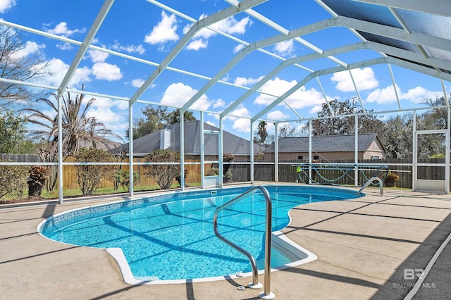 view of swimming pool with a lanai, a fenced in pool, a fenced backyard, and a patio area