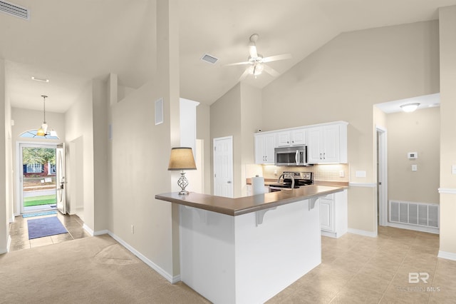 kitchen with white cabinetry, visible vents, and stainless steel appliances