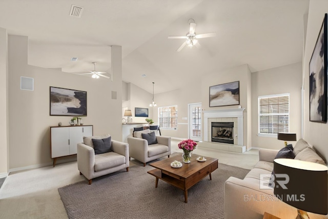 living area featuring light carpet, plenty of natural light, and ceiling fan