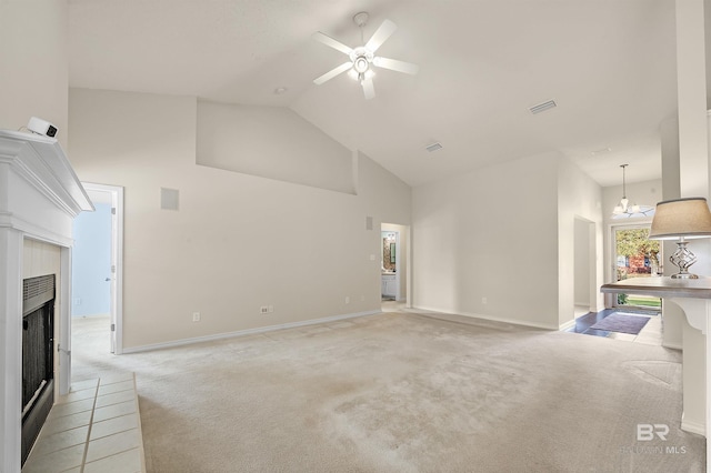 living area with visible vents, light carpet, high vaulted ceiling, a fireplace with raised hearth, and ceiling fan with notable chandelier