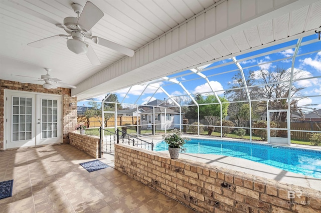 view of pool with a patio, a fenced backyard, french doors, and a lanai