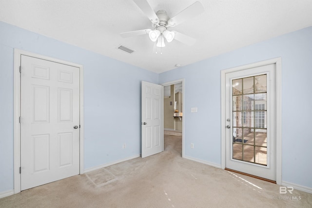 unfurnished bedroom with baseboards, visible vents, and light carpet