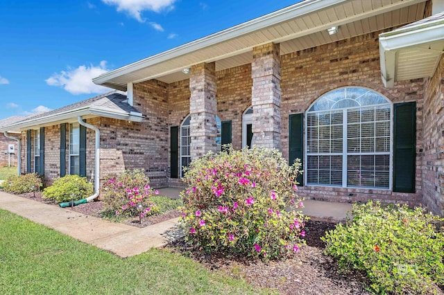 doorway to property with brick siding