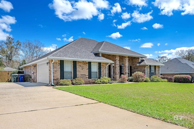 view of front of home with a front yard, driveway, roof with shingles, a garage, and brick siding