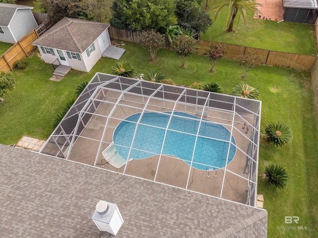 view of basketball court with a fenced backyard, a fenced in pool, and a lawn