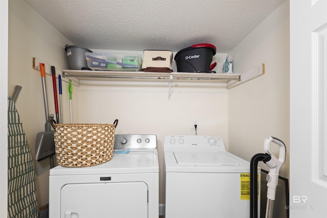 26115 Perdido Beach Blvd Unit 4-A, Orange Beach, AL 36561 - laundry room featuring washing machine and clothes dryer and a textured ceiling