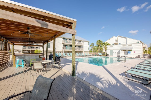 26115 Perdido Beach Blvd Unit 4-A, Orange Beach, AL 36561 - community pool featuring a deck, outdoor dining space, a ceiling fan, and a patio area