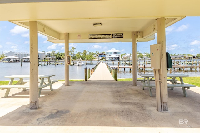 26115 Perdido Beach Blvd Unit 4-A, Orange Beach, AL 36561 - view of patio featuring a dock and a water view