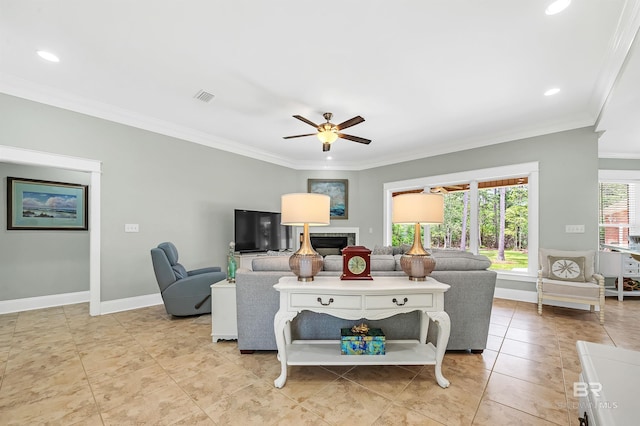 8954 Bay Point Dr, Elberta, AL 36530 - living room featuring crown molding, a fireplace, a ceiling fan, baseboards, and visible vents