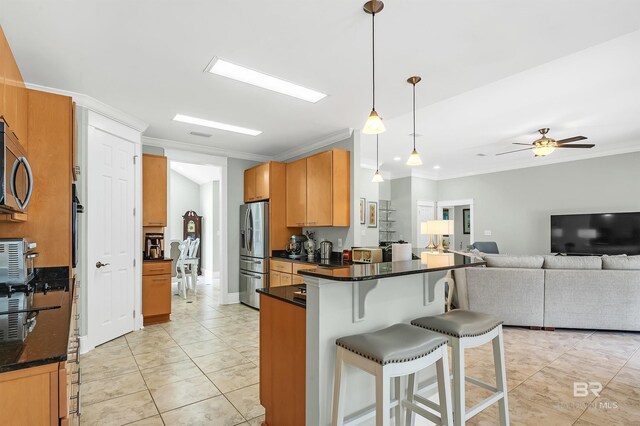 8954 Bay Point Dr, Elberta, AL 36530 - kitchen featuring ornamental molding, appliances with stainless steel finishes, and a breakfast bar