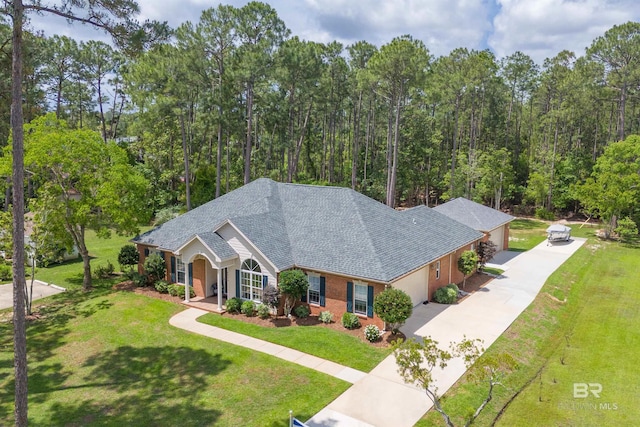 8954 Bay Point Dr, Elberta, AL 36530 - view of front facade featuring roof with shingles, a front lawn, brick siding, covered porch, and driveway