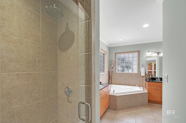 8954 Bay Point Dr, Elberta, AL 36530 - bathroom with crown molding, tile patterned flooring, vanity, a garden tub, and a stall shower
