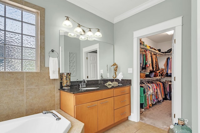 8954 Bay Point Dr, Elberta, AL 36530 - full bathroom with tile patterned flooring, crown molding, vanity, a bathing tub, and a spacious closet