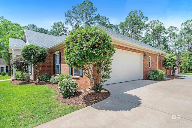 8954 Bay Point Dr, Elberta, AL 36530 - ranch-style house featuring roof with shingles, a front lawn, brick siding, a garage, and driveway