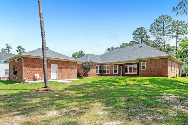 8954 Bay Point Dr, Elberta, AL 36530 - back of house with central air condition unit, a yard, and brick siding