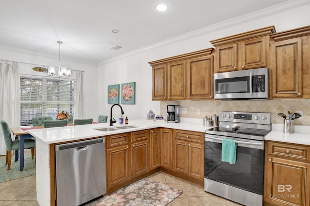 kitchen featuring appliances with stainless steel finishes, sink, ornamental molding, light tile patterned floors, and kitchen peninsula