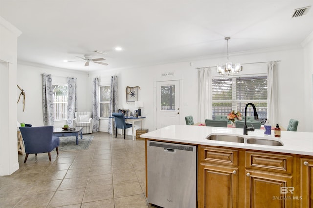 kitchen with ornamental molding, pendant lighting, sink, and stainless steel dishwasher