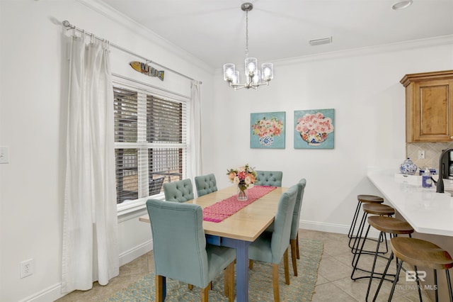 dining room with ornamental molding, light tile patterned flooring, and a notable chandelier