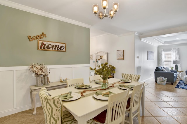 tiled dining room featuring a notable chandelier and crown molding