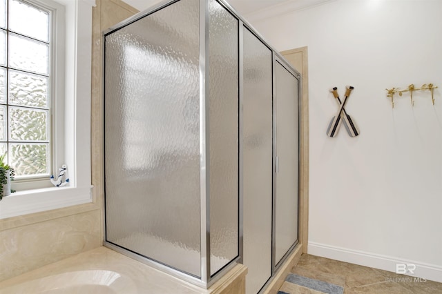 bathroom featuring tile patterned flooring, ornamental molding, and separate shower and tub