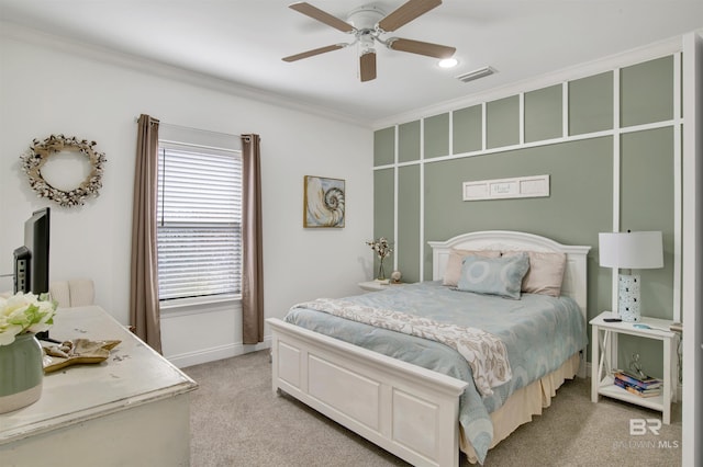 carpeted bedroom with crown molding and ceiling fan