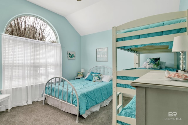 bedroom with light colored carpet and lofted ceiling