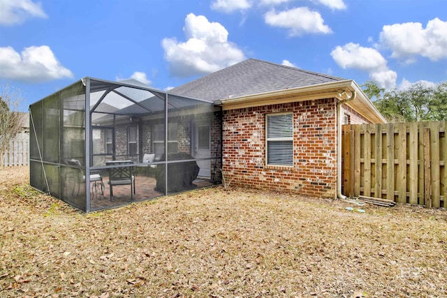 back of property featuring a patio and a lanai