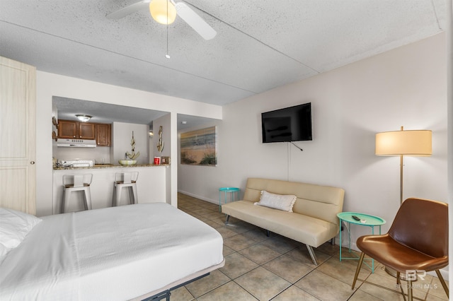 bedroom with ceiling fan and light tile patterned floors