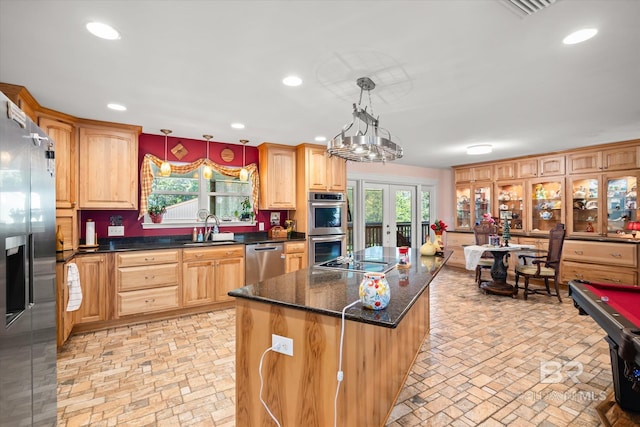 kitchen with sink, a center island, stainless steel appliances, billiards, and decorative light fixtures