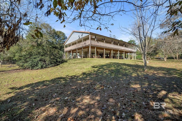 rear view of house featuring a yard and a deck