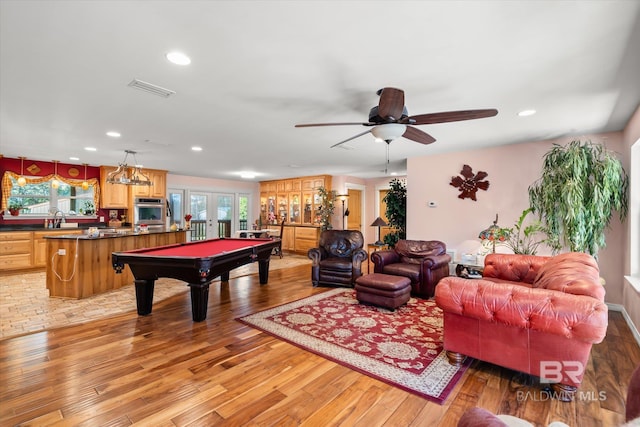 playroom with ceiling fan, light wood-type flooring, a wealth of natural light, and sink