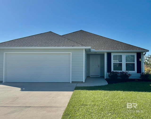 view of front of house with a garage and a front lawn