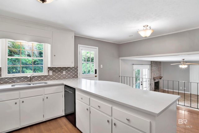 kitchen with white cabinets, backsplash, sink, light hardwood / wood-style floors, and ceiling fan