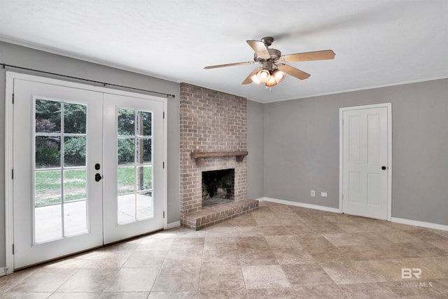 unfurnished living room with french doors, a brick fireplace, ceiling fan, brick wall, and light tile floors