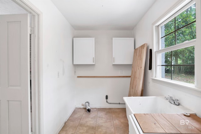 bathroom with plenty of natural light and tile floors