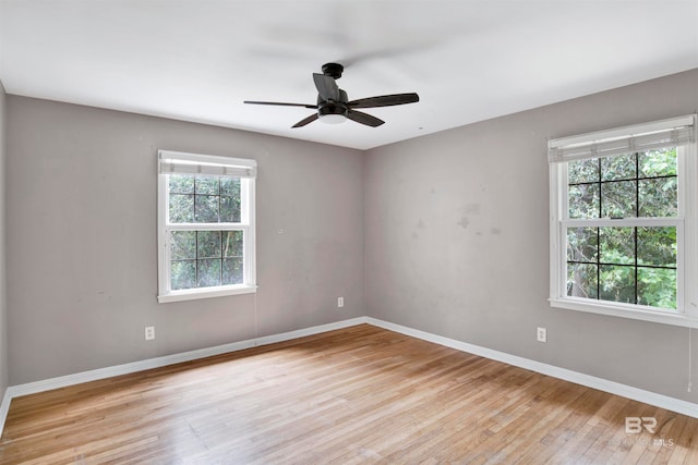 spare room with ceiling fan and light wood-type flooring