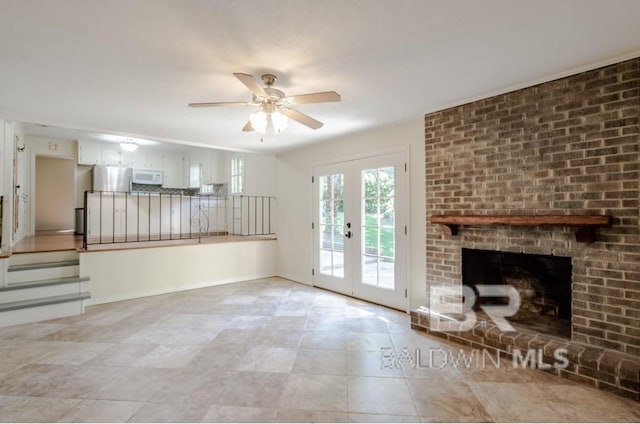 unfurnished living room with french doors, ceiling fan, light tile floors, and a fireplace