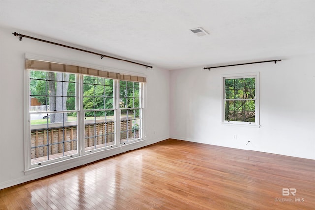 empty room with light hardwood / wood-style flooring