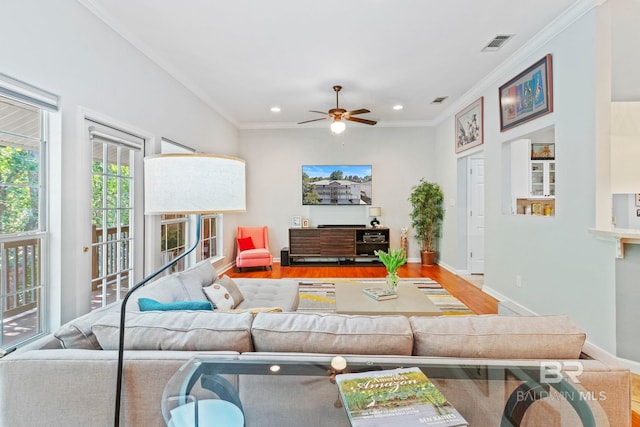 living room with ceiling fan, ornamental molding, and hardwood / wood-style floors