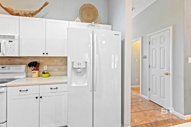 kitchen with white cabinetry, light tile patterned floors, backsplash, and white appliances