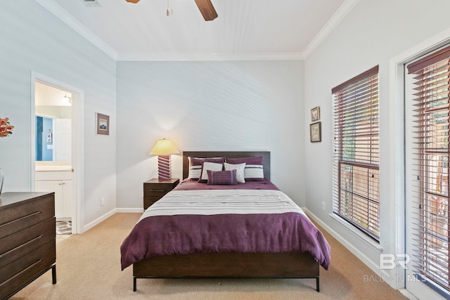 bedroom featuring crown molding, ensuite bath, light colored carpet, and ceiling fan