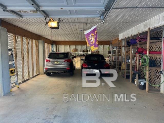 garage featuring a garage door opener and a carport